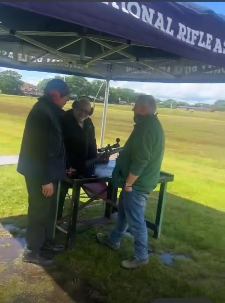 Checking a rifle under the NRA gazebo at Bisley